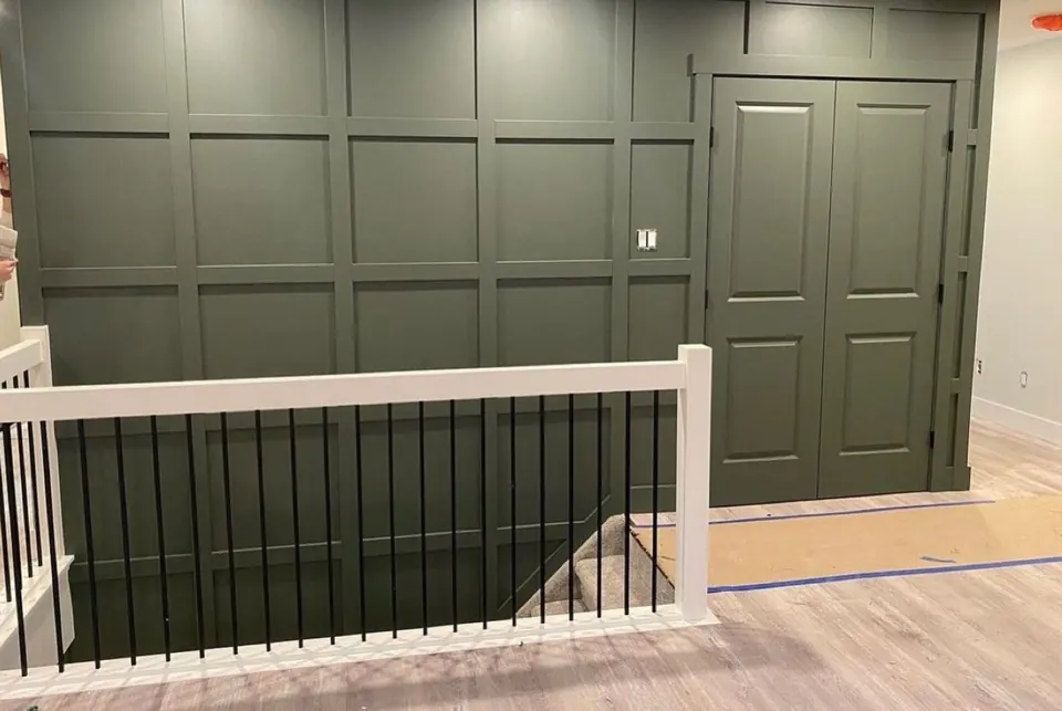 Board-and-batten accent wall painted deep green