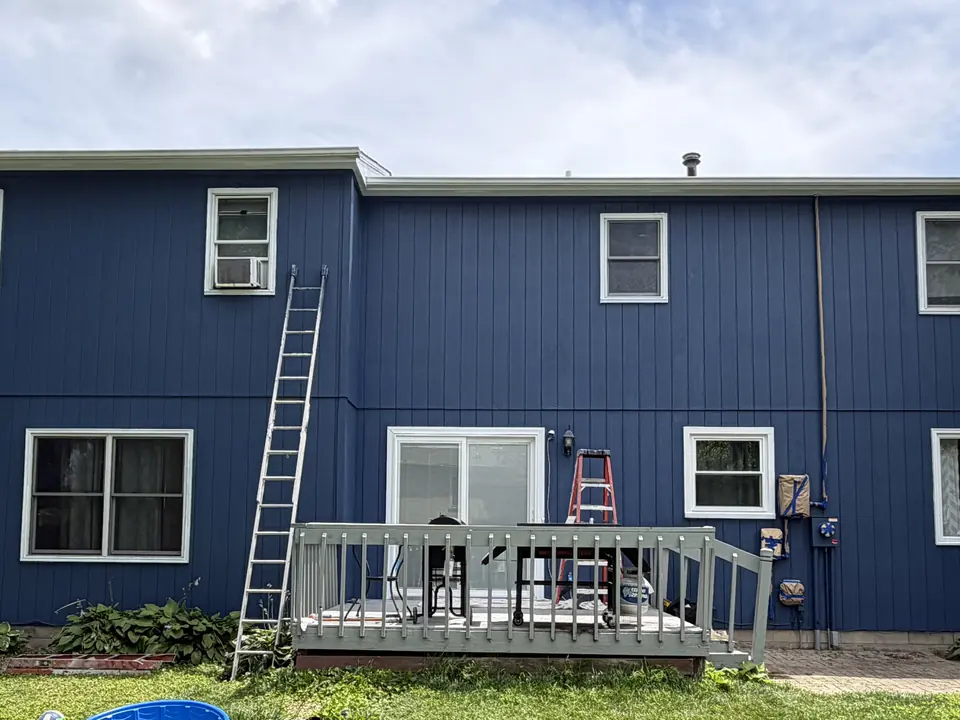 After: Two-story home repainted from yellow to blue