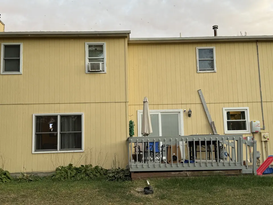 Before: Two-story home repainted from yellow to blue