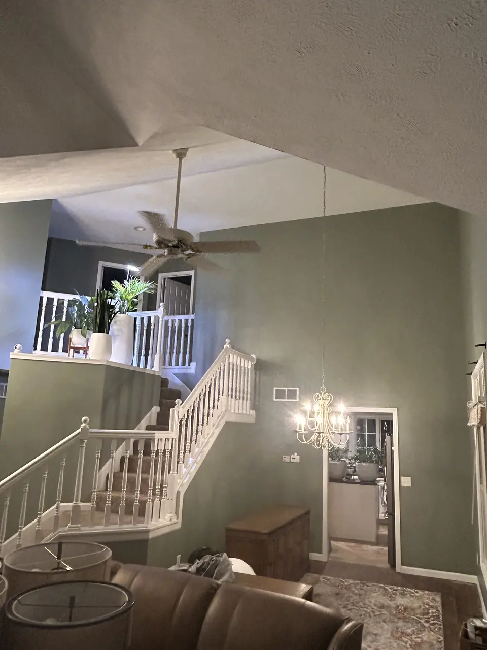 Vaulted living room and stairwell painted deep green